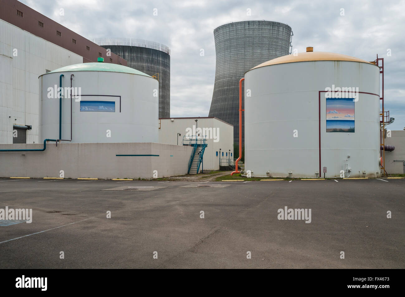Nuclear plant storage tanks with cooling tower in the background at