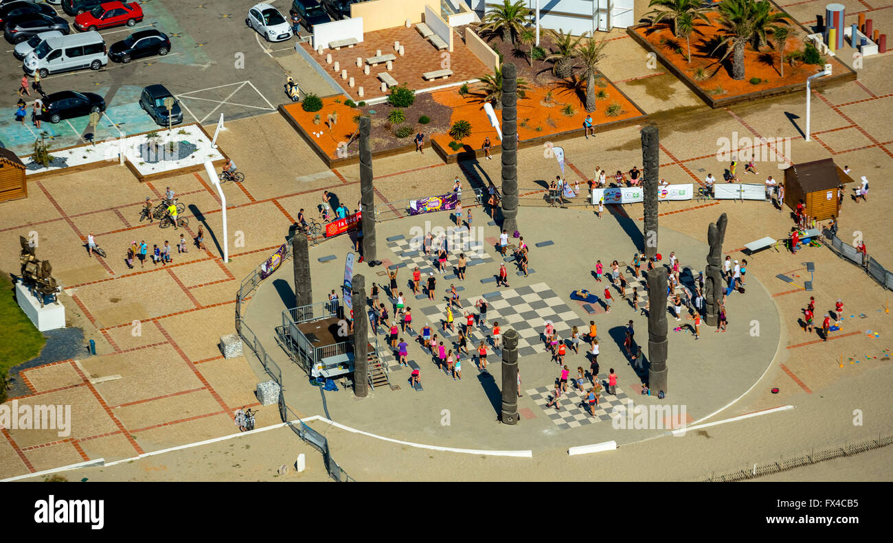 Aerial view, Open aerobics and steppes on the promenade of Le Barcarès under palm trees, Le Barcarès, France, Stock Photo