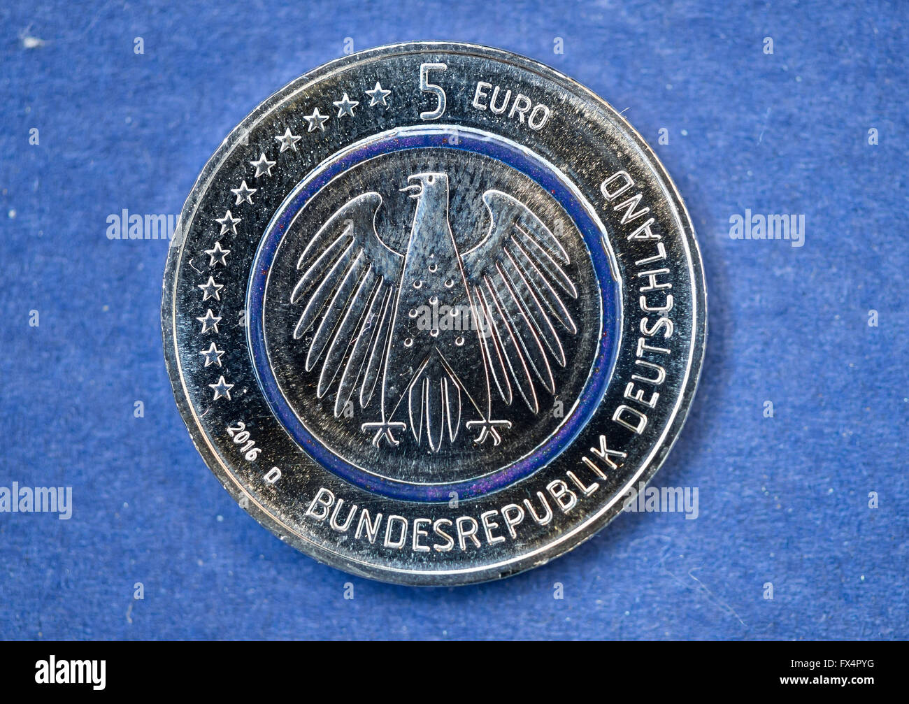 Munich, Germany. 11th Apr, 2016. The new 5-euro coin 'Blue Planet Earth'  can be seen in the Central Mint in Munich, Germany, 11 April 2016. The  so-called 'tri-material coin' has a transparent,