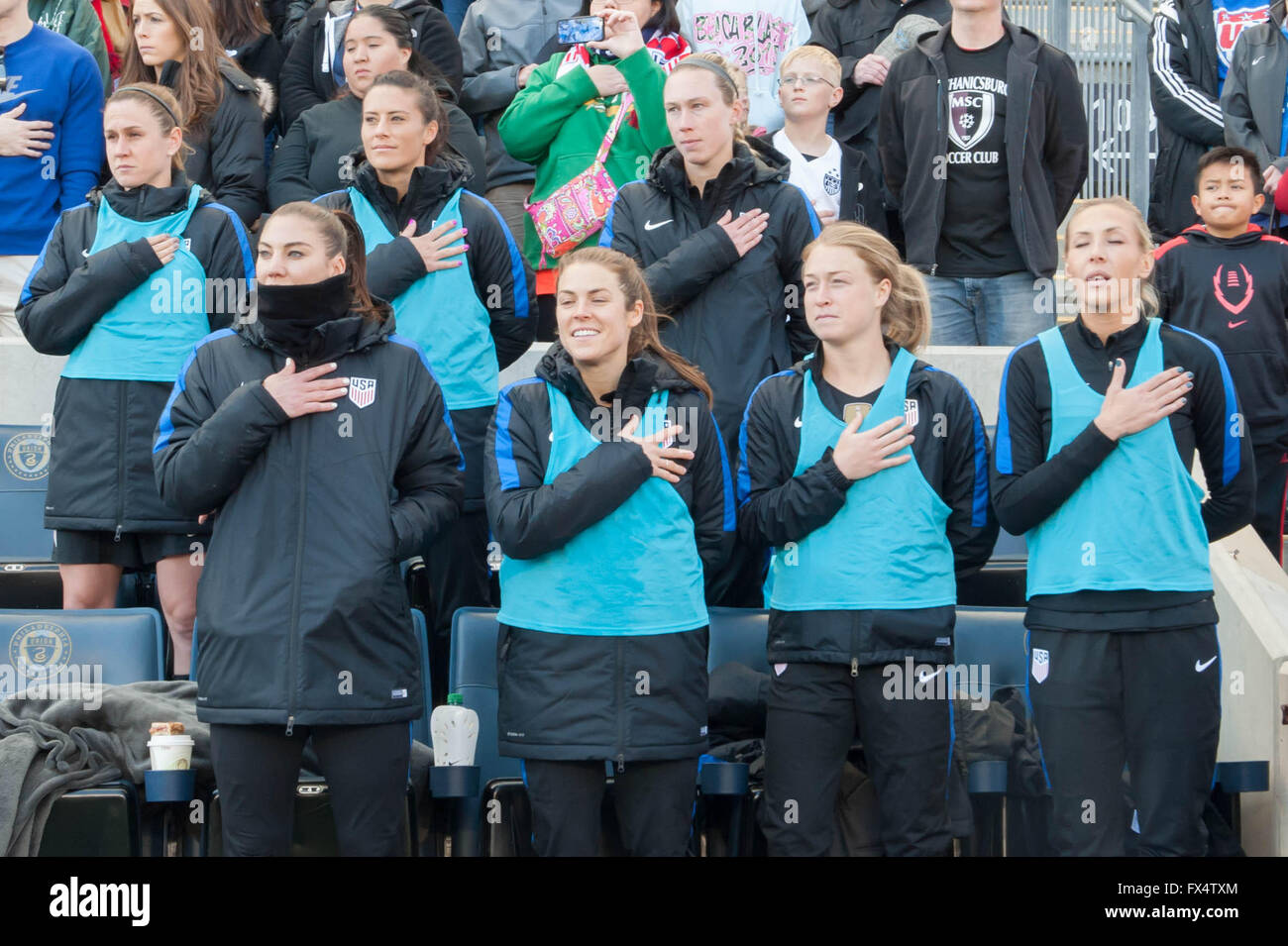 Women's football / soccer - Chester, Pennsylvania, USA. 10th April 2016. Hope Solo, Allie Long and other members of the United States Women's soccer team during the Star Spangled Banner national anthem Credit:  Don Mennig/Alamy Live News Stock Photo