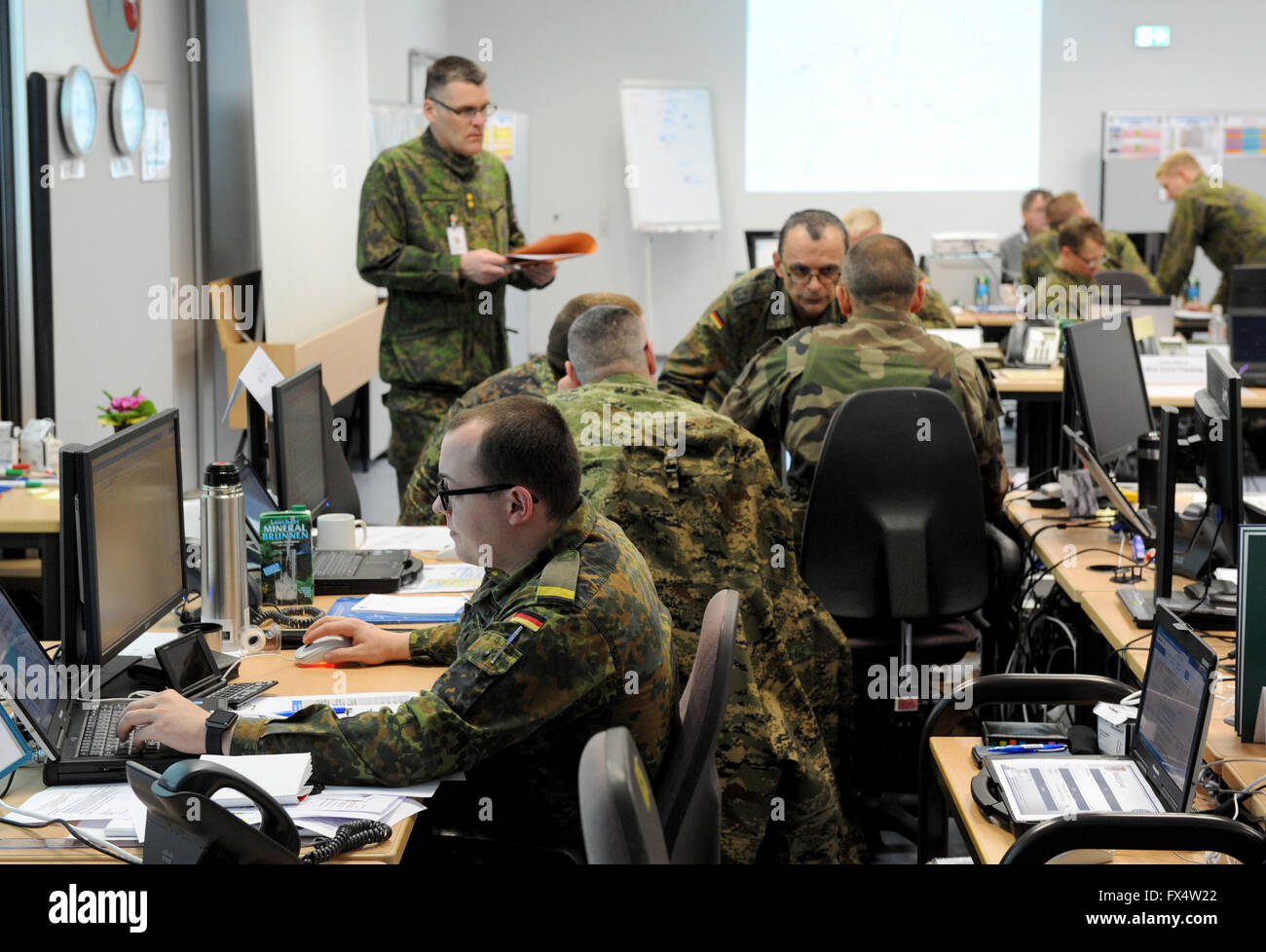 Garlstedt, Germany. 11th Apr, 2016. Soldiers from several countries use computers to plan the deployment of troops in a hall of the logistics school of the German armed forces in Garlstedt, Germany, 11 April 2016. The actual exercise is to be held on the sea and in the air in northwestern Germany until 22 April. Some 2,000 soldiers from 12 countries are taking part in the 'Joint Derby 16' large-scale exercise. Photo: INGO WAGNER/dpa/Alamy Live News Stock Photo