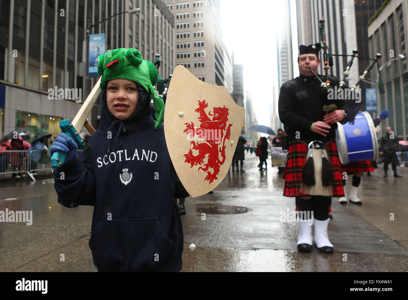 April 9, 2016 - New York City, NY, U.S - A little Scottish warrior leads the Pipes and drums of Tir na nog NYC as they march in the New York Tartan Day Parade, the annual celebration of Scottish heritage and pride in the United States. Thousands of Scots and people of Scottish heritage from across the world descended on the Big Apple for the celebrations, which marked the end of the city's Tartan Week.  The rain didn't stop kilt-wearing bagpipers, drummers, shinty players, Vikings or Scottish Clans from having a great time. (Credit Image: © Krista Kennell via ZUMA Wire) Stock Photo