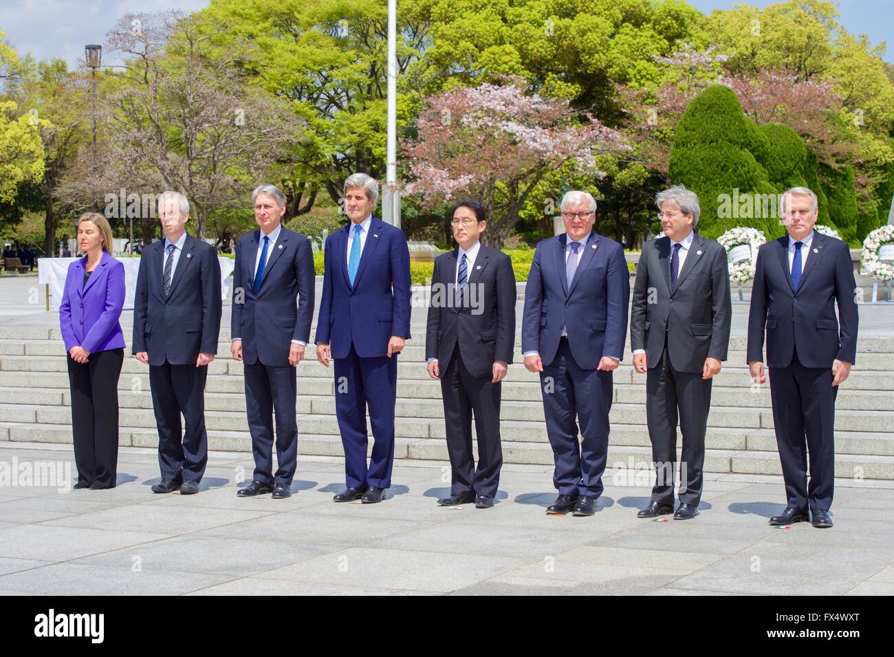 Hiroshima, Japan. 11th Apr, 2016. U.S Secretary of State John Kerry stands with other G-7 Foreign Ministers during a visit the Hiroshima Peace Memorial during a break from meetings April 11, 2016 in Hiroshima, Japan. Foreign Ministers include (L-R): High Representative of the European Union Federica Mogherini, Canadian Foreign Minister Stephane Dion, British Foreign Secretary Philip Hammond, U.S. Secretary of State John Kerry, Japanese Foreign Minister Fumio Kishida, German Frank-Walter Steinmeier, Italian Foreign Minister Paolo Gentiloni and French Foreign Minister Jean-Marc Ayrault. Stock Photo