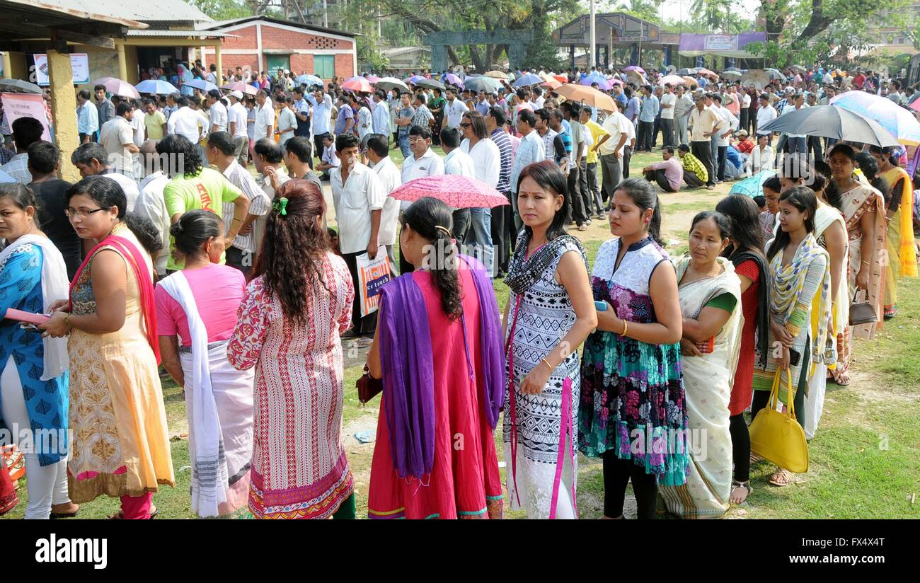 Tribal women stand in long lines to cast their vote at a remote polling station for the Assam Assembly elections April 11, 2016 in Maidamgaon, Assam, India. Long lines at polling stations and high turn out resulted in sporadic clashes and police firing that resulted in the death of an elderly voter. Stock Photo