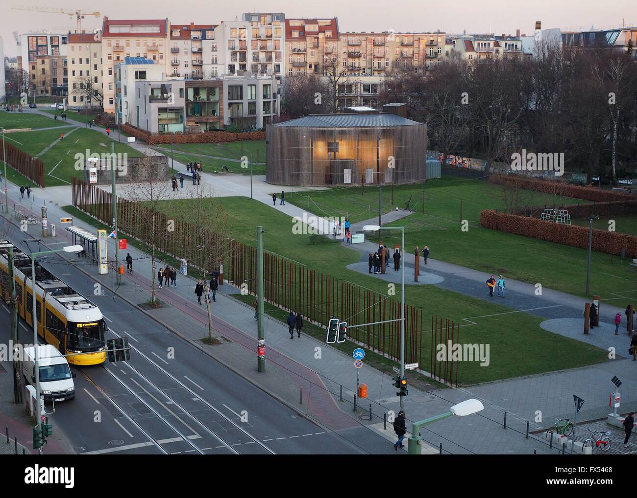 People walk next to and on the terrain of the Berlin Wall Memorial in Berlin at Bernauer Straße on December, 30, 2015. The photo was taken from the visitors platform of the Berlin Wall Memorial. Photo: Wolfram Steinberg/dpa Stock Photo
