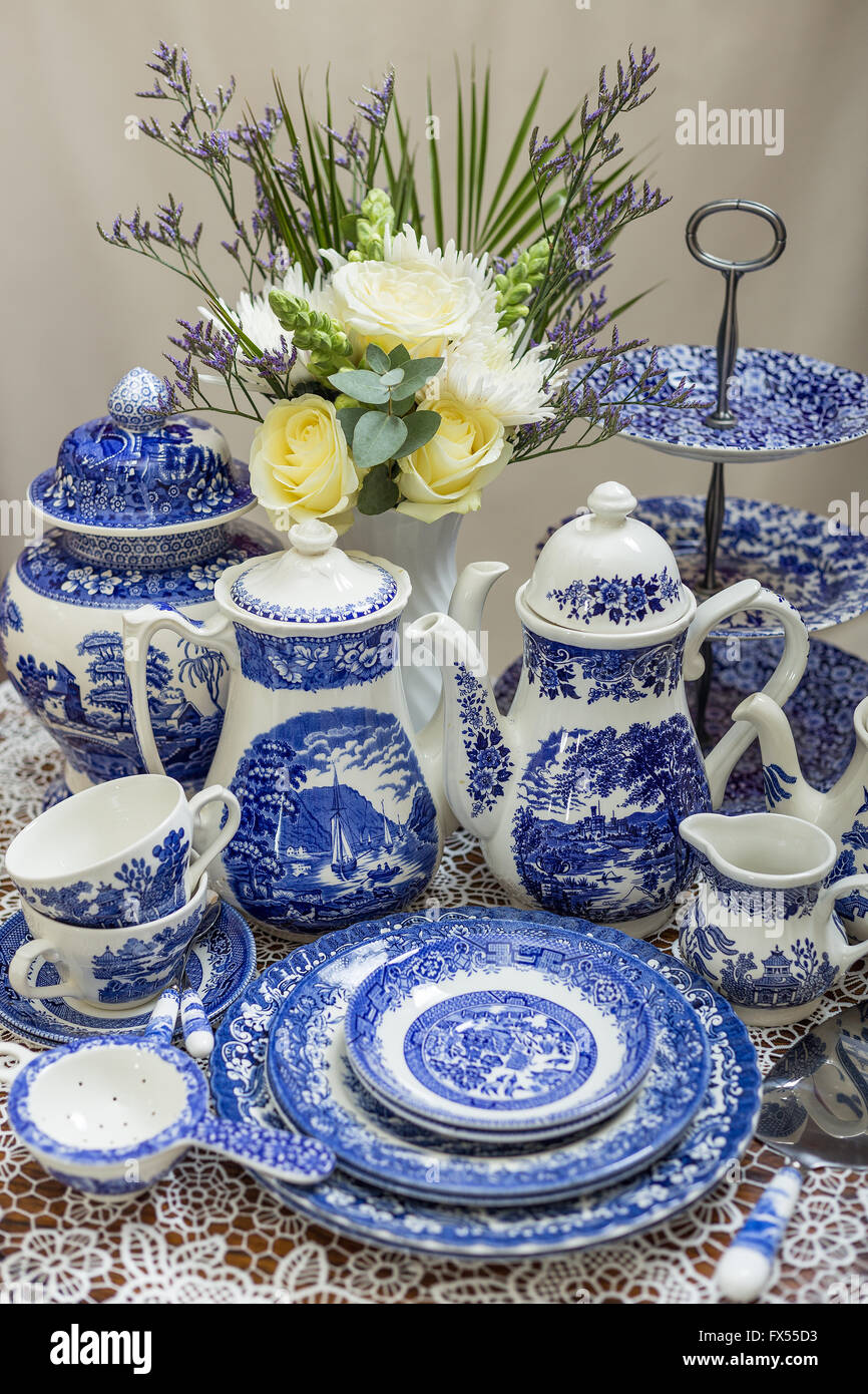 Blue and white transferware Spode willow pattern tea set on lace cloth for wedding afternoon tea with bouquet Stock Photo Alamy