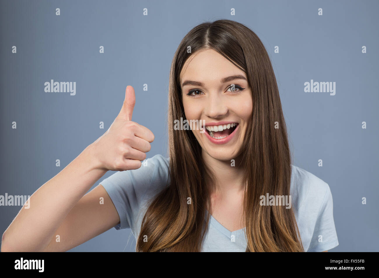 Cheerful charming girl thumbing up Stock Photo - Alamy