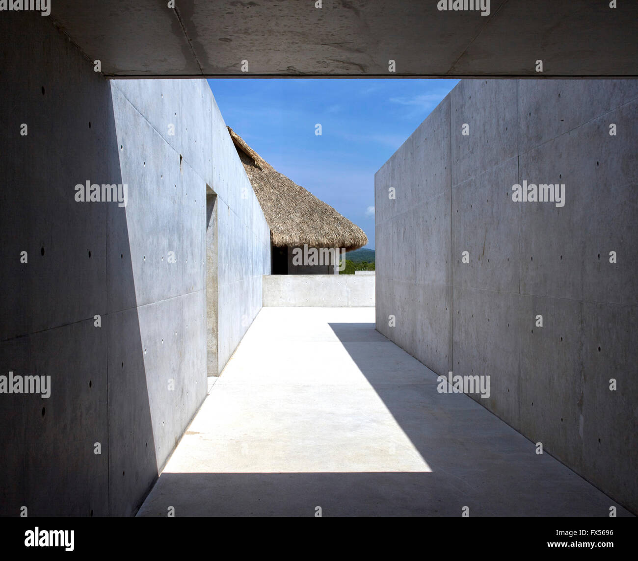 Framed view down main walkway between studios and Palapa. Casa Wabi, Puerto Escondido, Mexico. Architect: Tadao Ando, 2015. Stock Photo