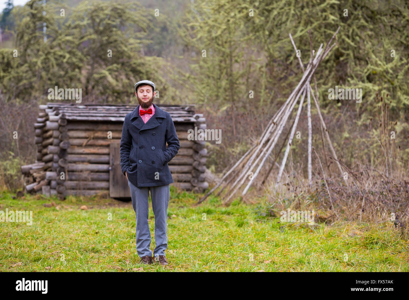 Trendy hipster guy outdoors in the winter in a fashion portrait of the handsome man. Stock Photo