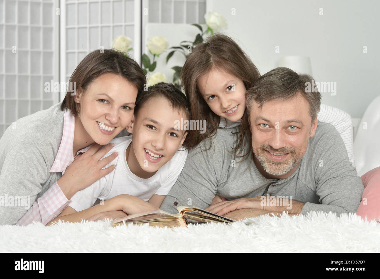 family at home with book Stock Photo