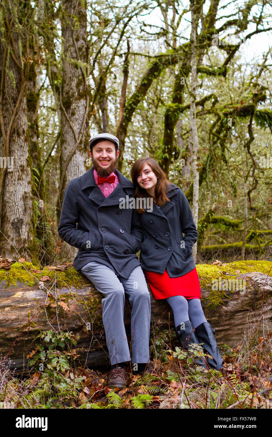 Engaged and in love, this couple poses for portraits outdoors in the winter. Stock Photo