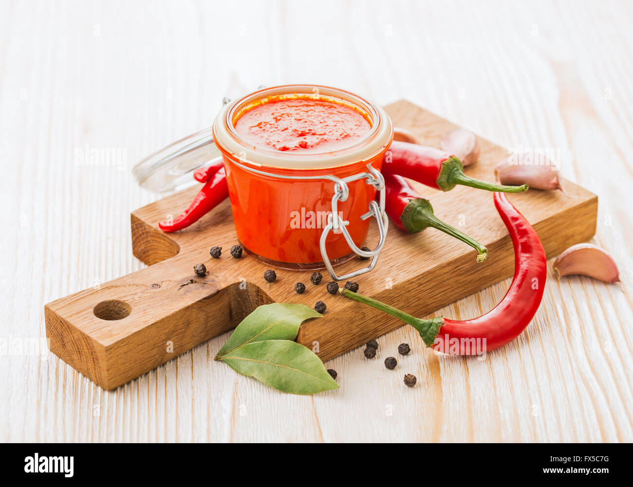Homemade chili pepper hot sauce with ingredients Stock Photo