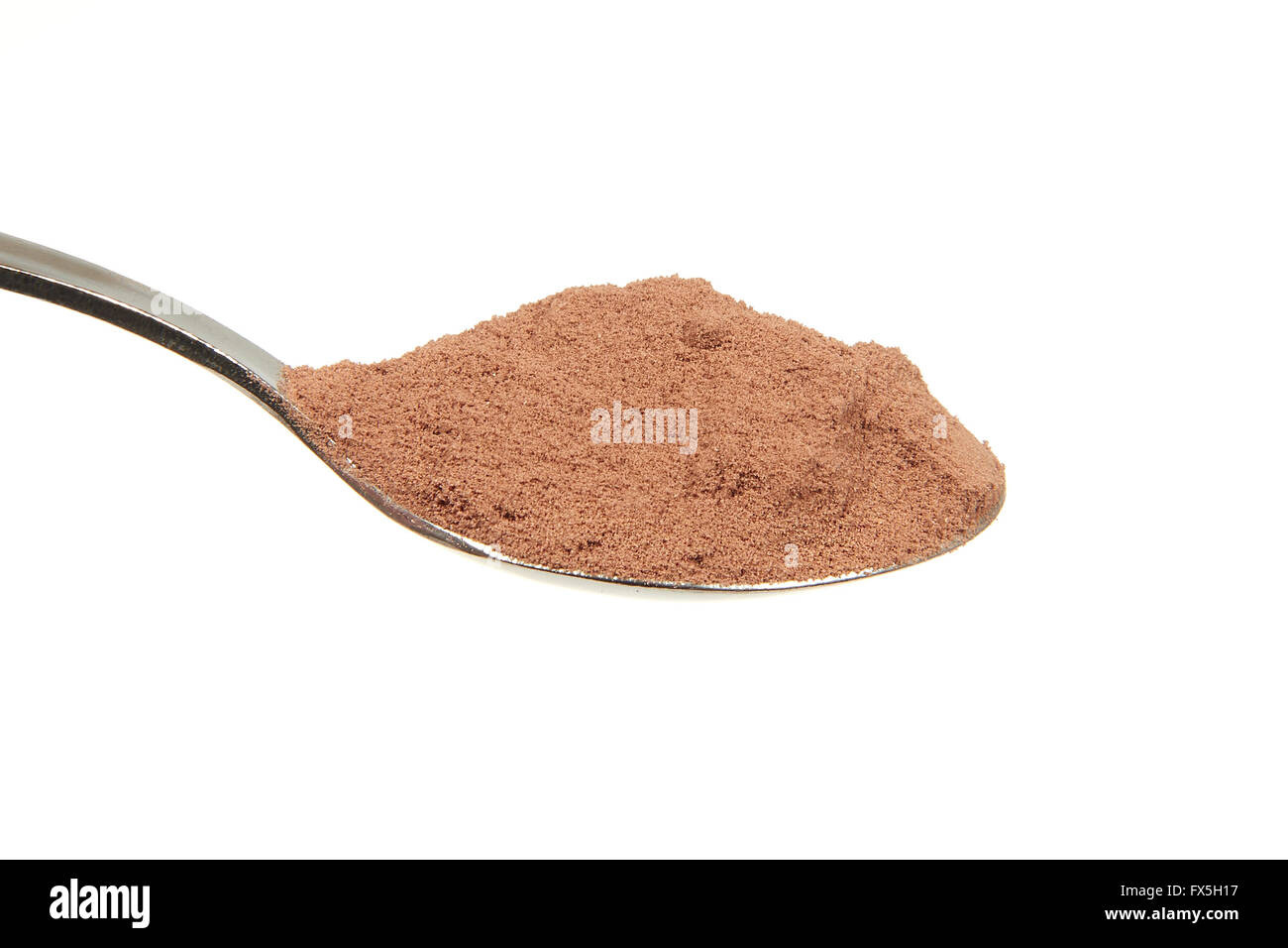 Cocoa powder on a teaspoon on a white background Stock Photo