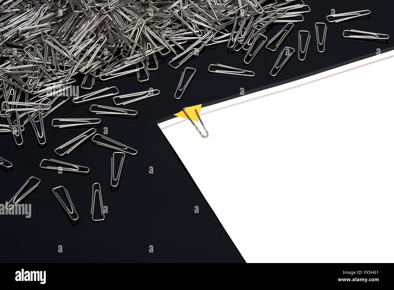 Paper clips with paper note on black background Stock Photo - Alamy