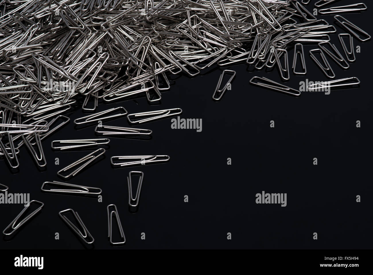 Paper clips on black background Stock Photo - Alamy