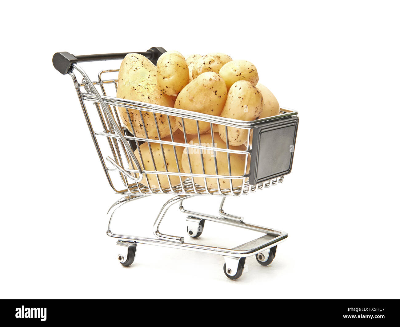 Shopping cart filled with potatoes isolated on white Stock Photo