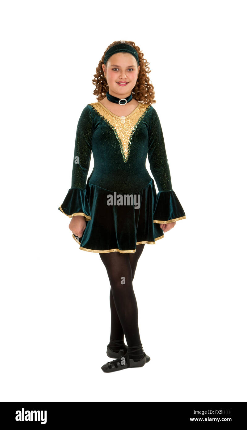 Irish or Celtic Teen Dancer posing with hands by side and feet in fith, wearing a Green Velvet  Recital Costume shot against a white background. Stock Photo