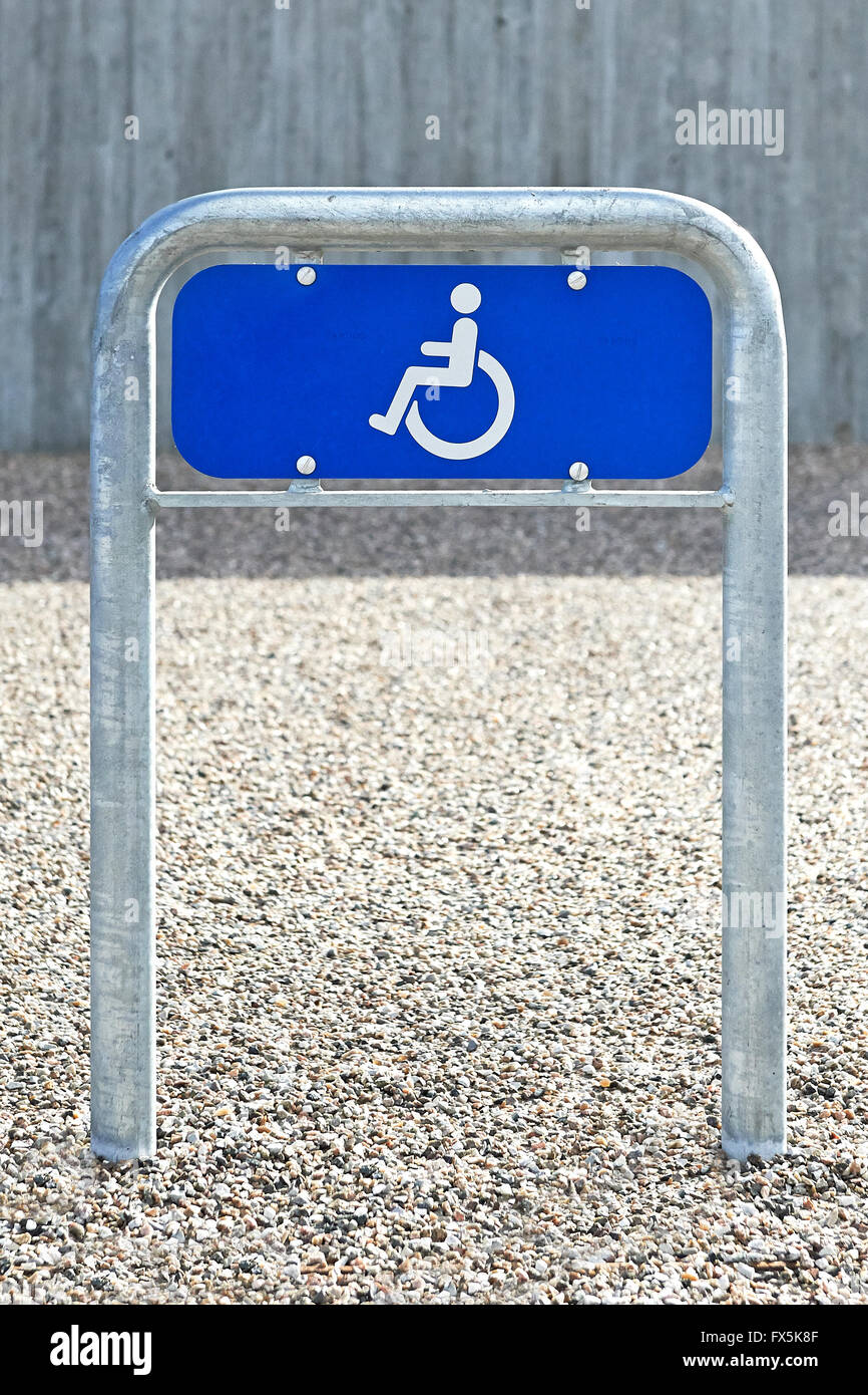 Blue parking lot wheelchair handicap sign Stock Photo