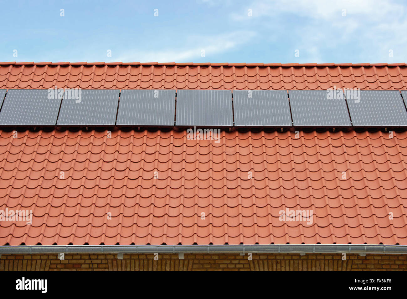 Flat plate solar thermal collectors on a red tile roof Stock Photo - Alamy
