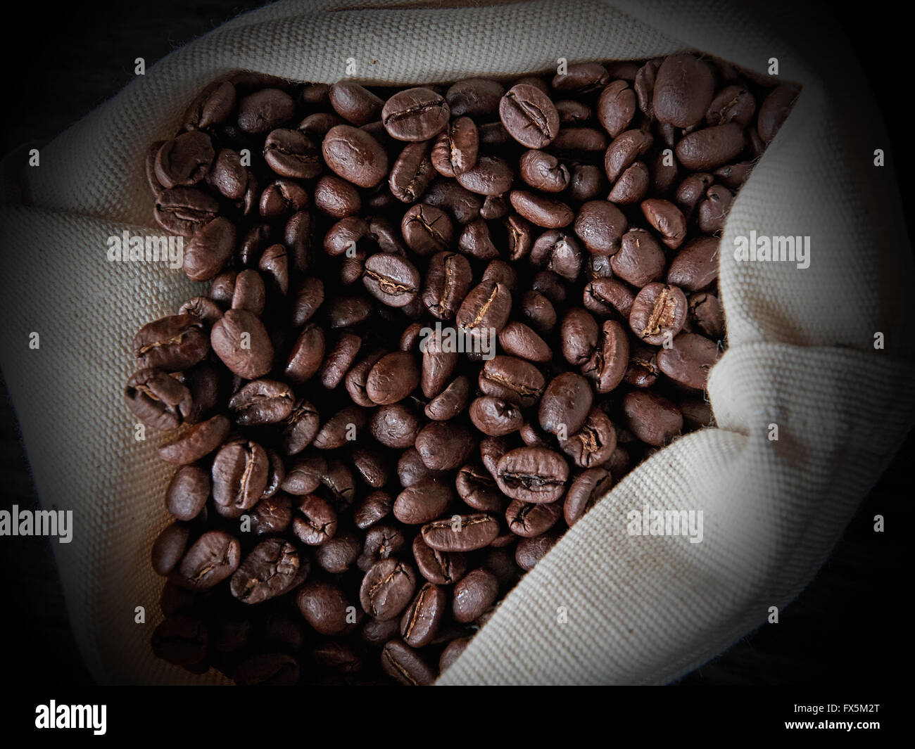 Closeup image of coffee beans in a white canvas bag Stock Photo - Alamy