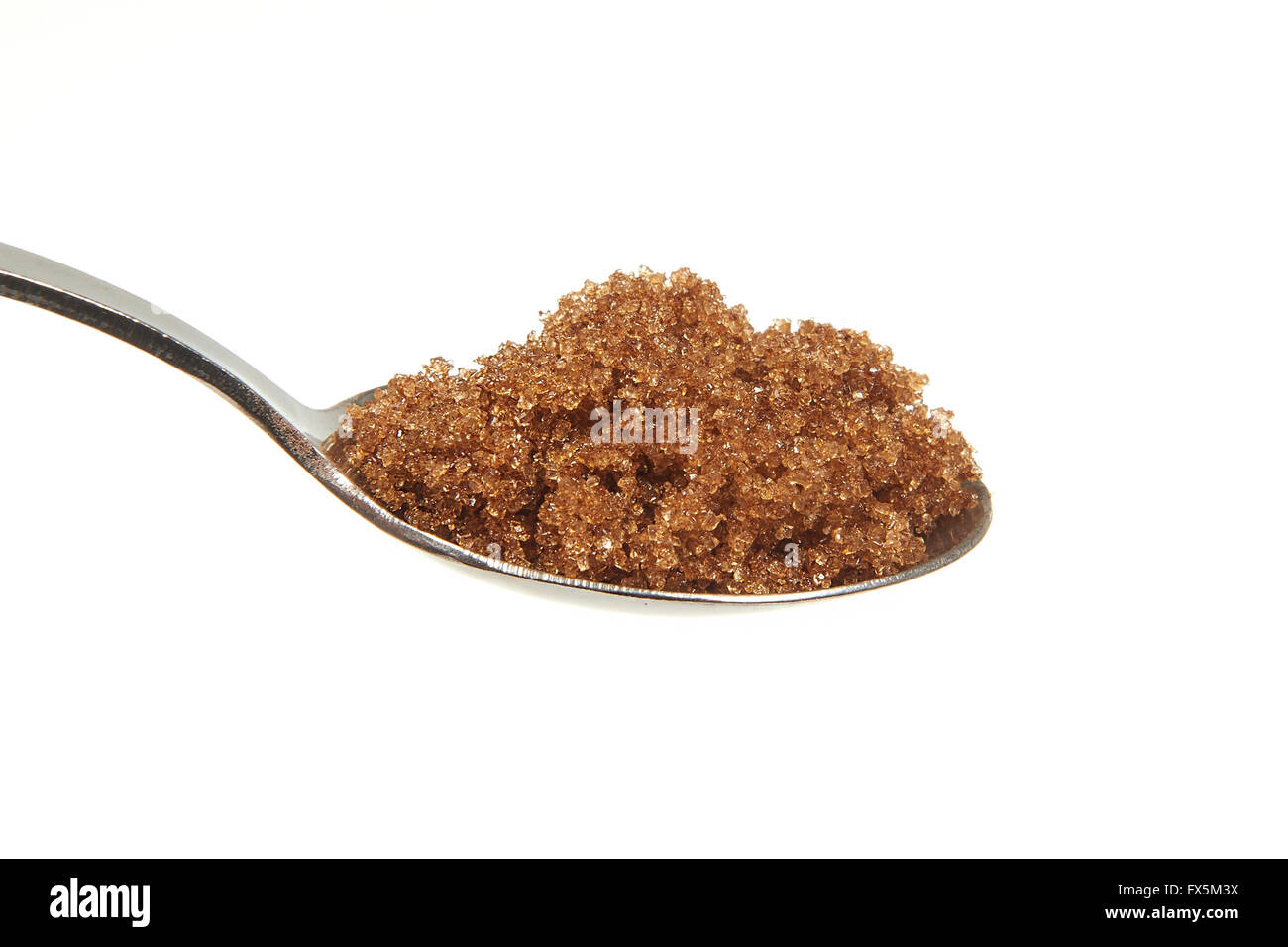 Brown sugar on a teaspoon on a white background Stock Photo Alamy