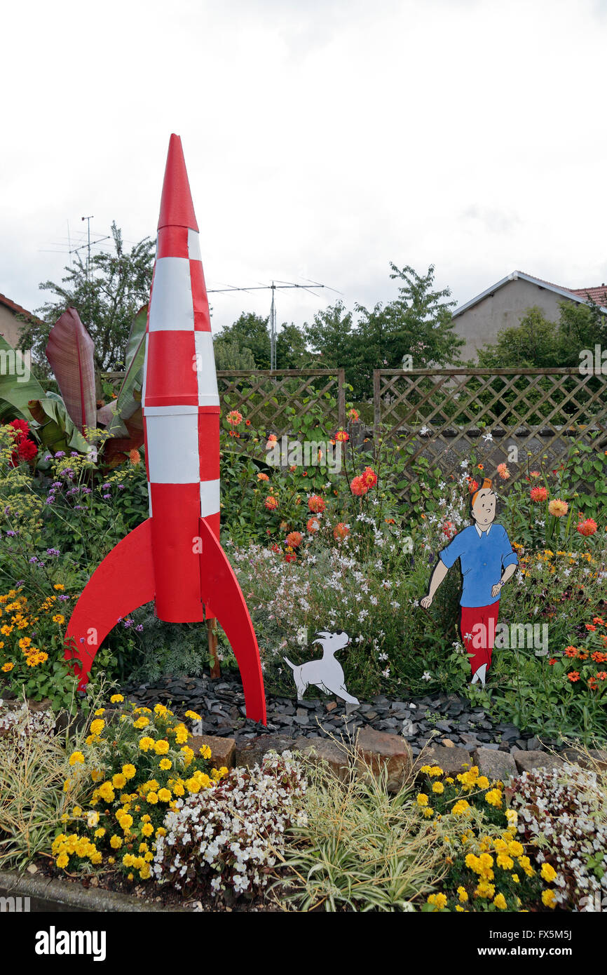 Comic character inspired garden furniture (here of Tintin and a rocket)  in a small village near Verdun in France. Stock Photo