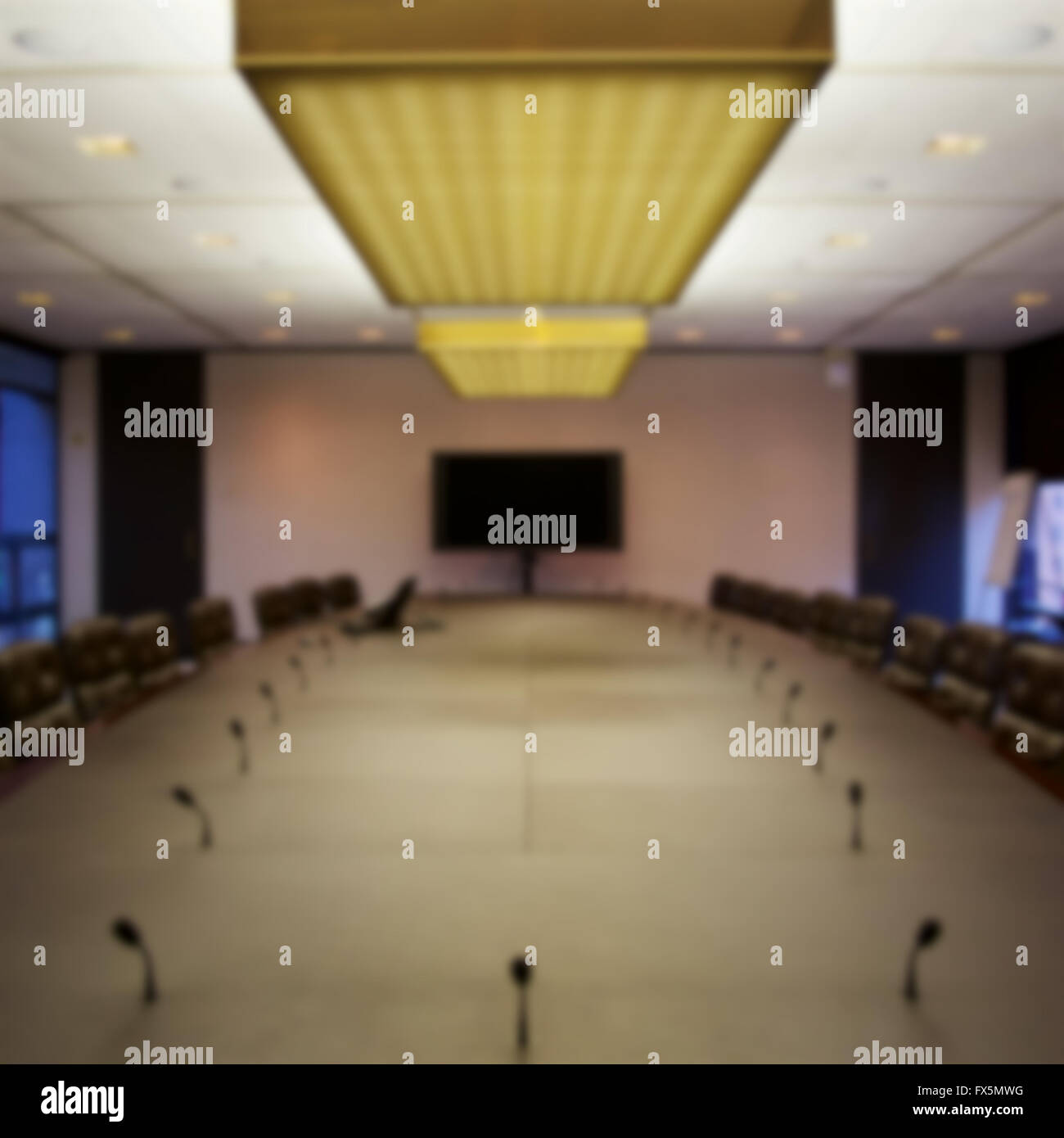 Background blur of empty seats at a board room table. Stock Photo