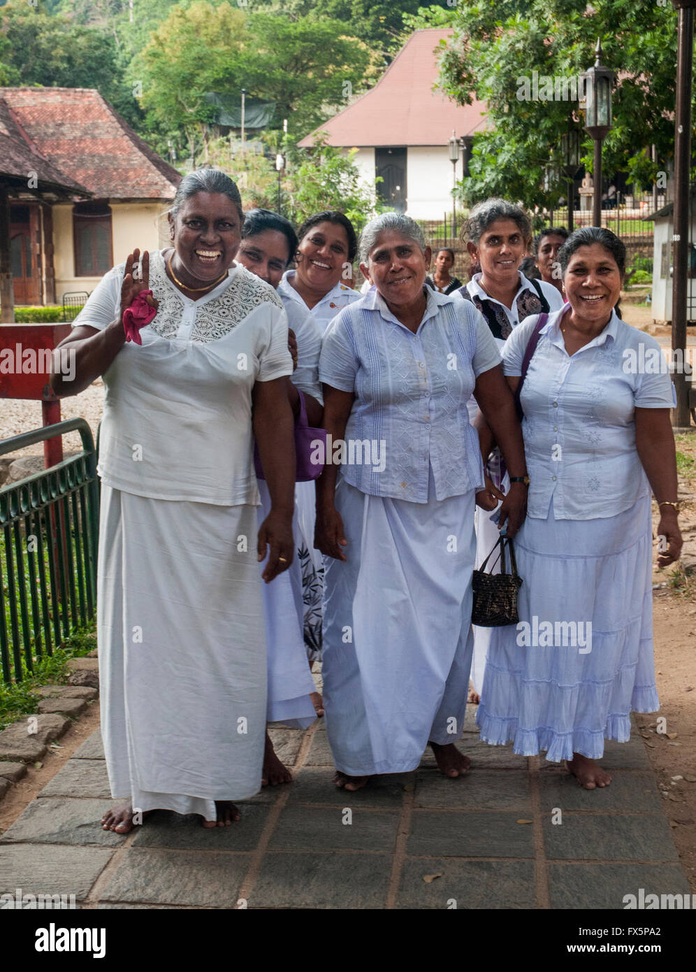 Female pilgrims visiting the Temple of the Tooth (Dalada Maligawa) at Kandy, Sri Lanka Stock Photo