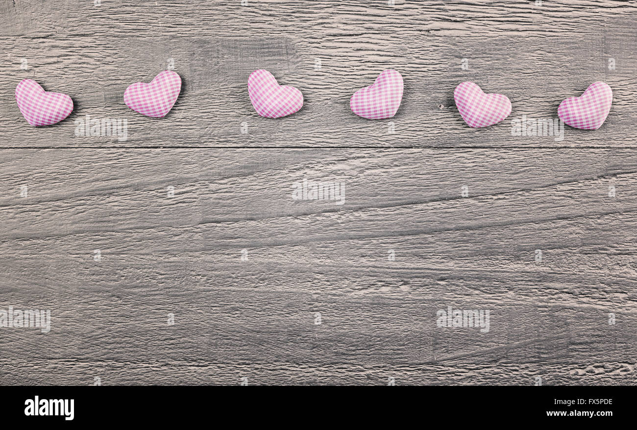 wooden background with gingham hearts toning in vintage style Stock Photo