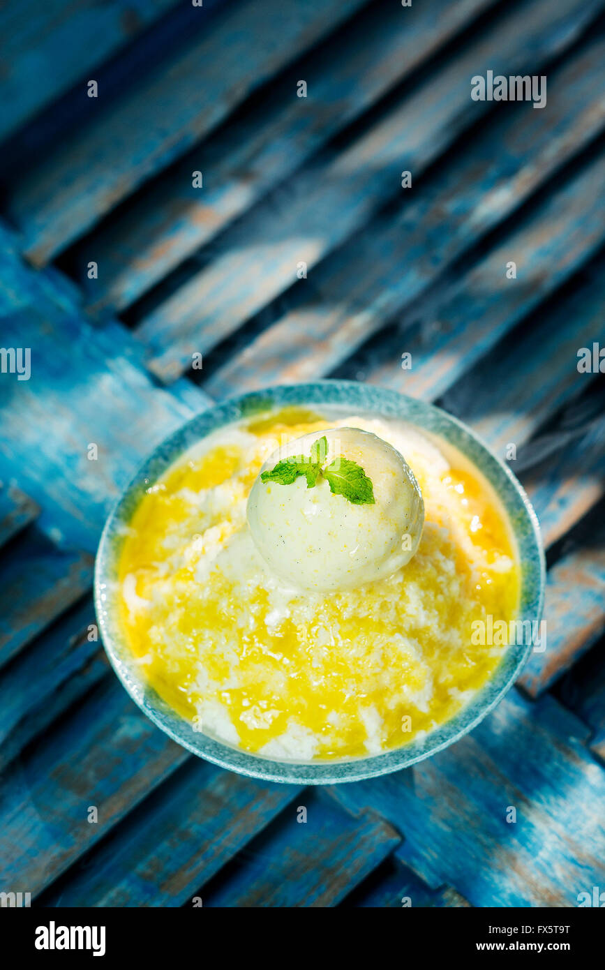 coconut sorbet with mango coulis sauce and vanilla ice cream Stock