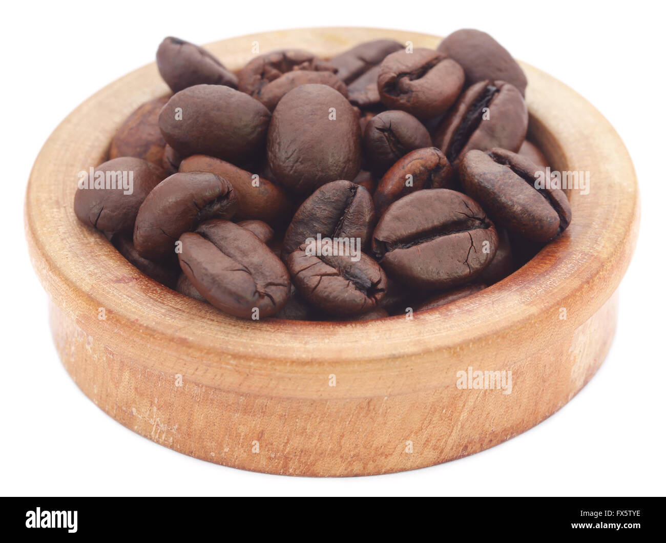 Roasted coffee bean in a wooden bowl over white background Stock Photo ...