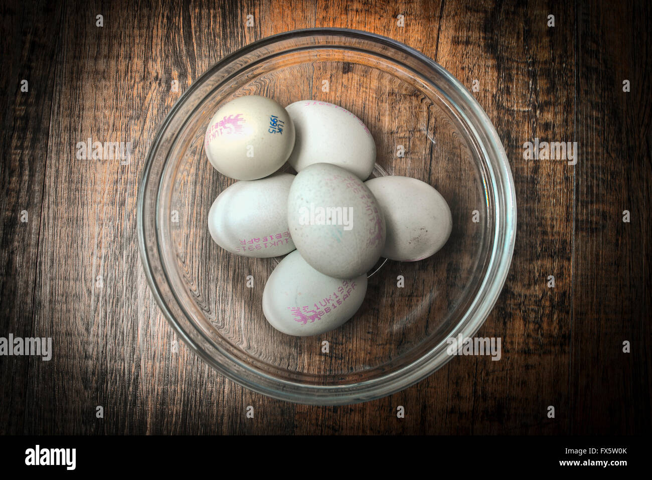 half dozen eggs in a glass bowl Stock Photo