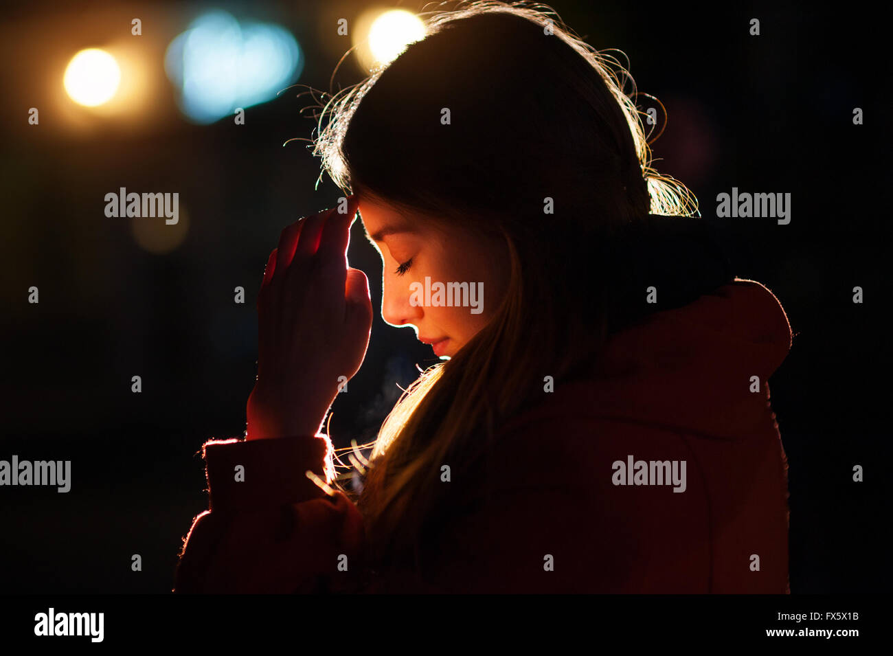 Closeup portrait of a young  woman praying Stock Photo