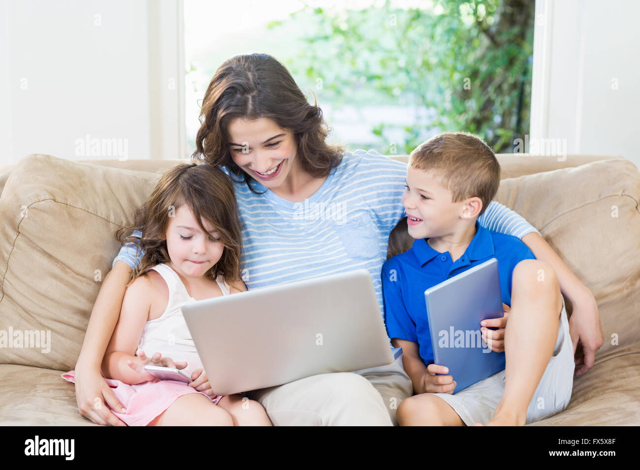 Family using laptop, digital tablet and mobile phone Stock Photo - Alamy