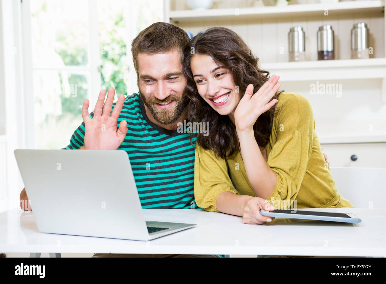 Couple having video chat on laptop Stock Photo