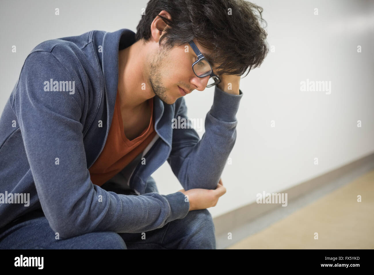 Thoughtful student sitting on chair Stock Photo