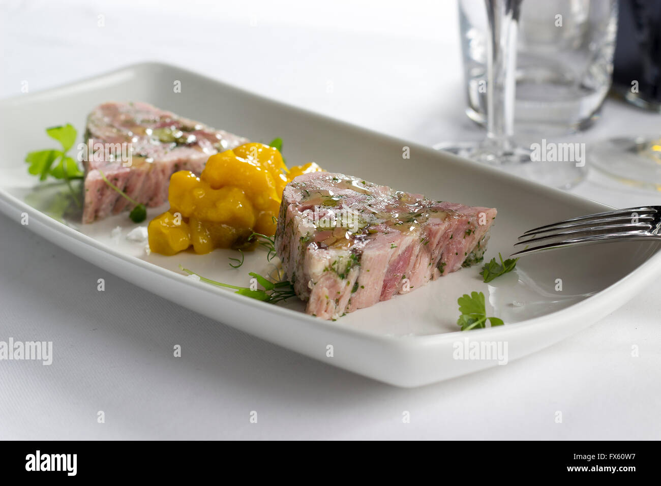 Ham hock & trotter terrine with piccalilli Stock Photo