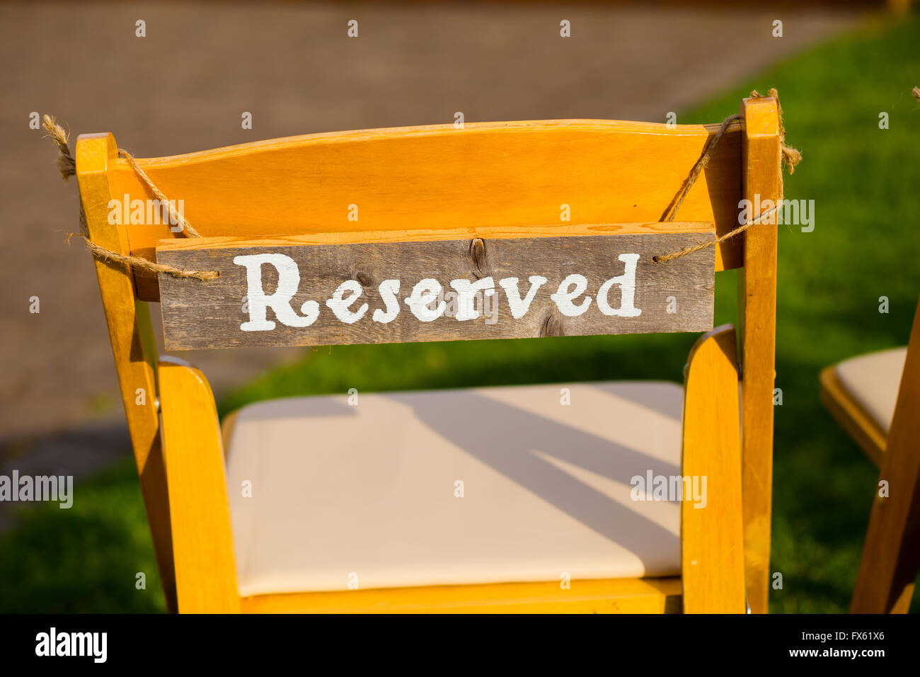 Reserved seating for family at an outdoor wedding ceremony. Stock Photo