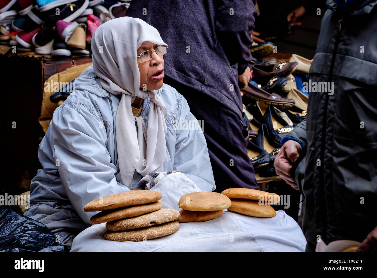 A woman selling bread in the medina in Marrakech, Morocco, North Africa Stock Photo