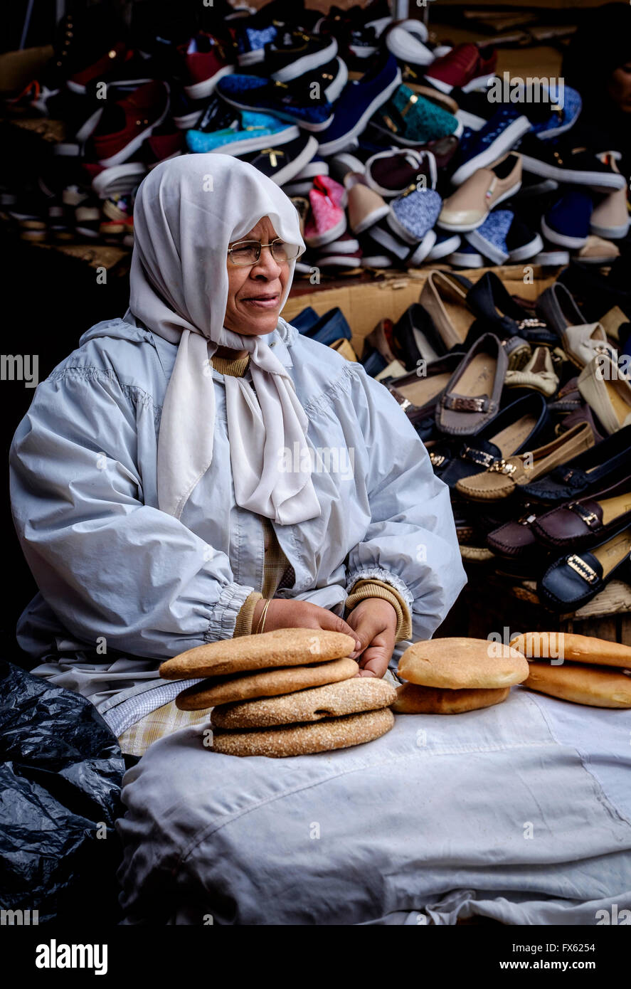 A woman selling bread in the medina in Marrakech, Morocco, North Africa Stock Photo