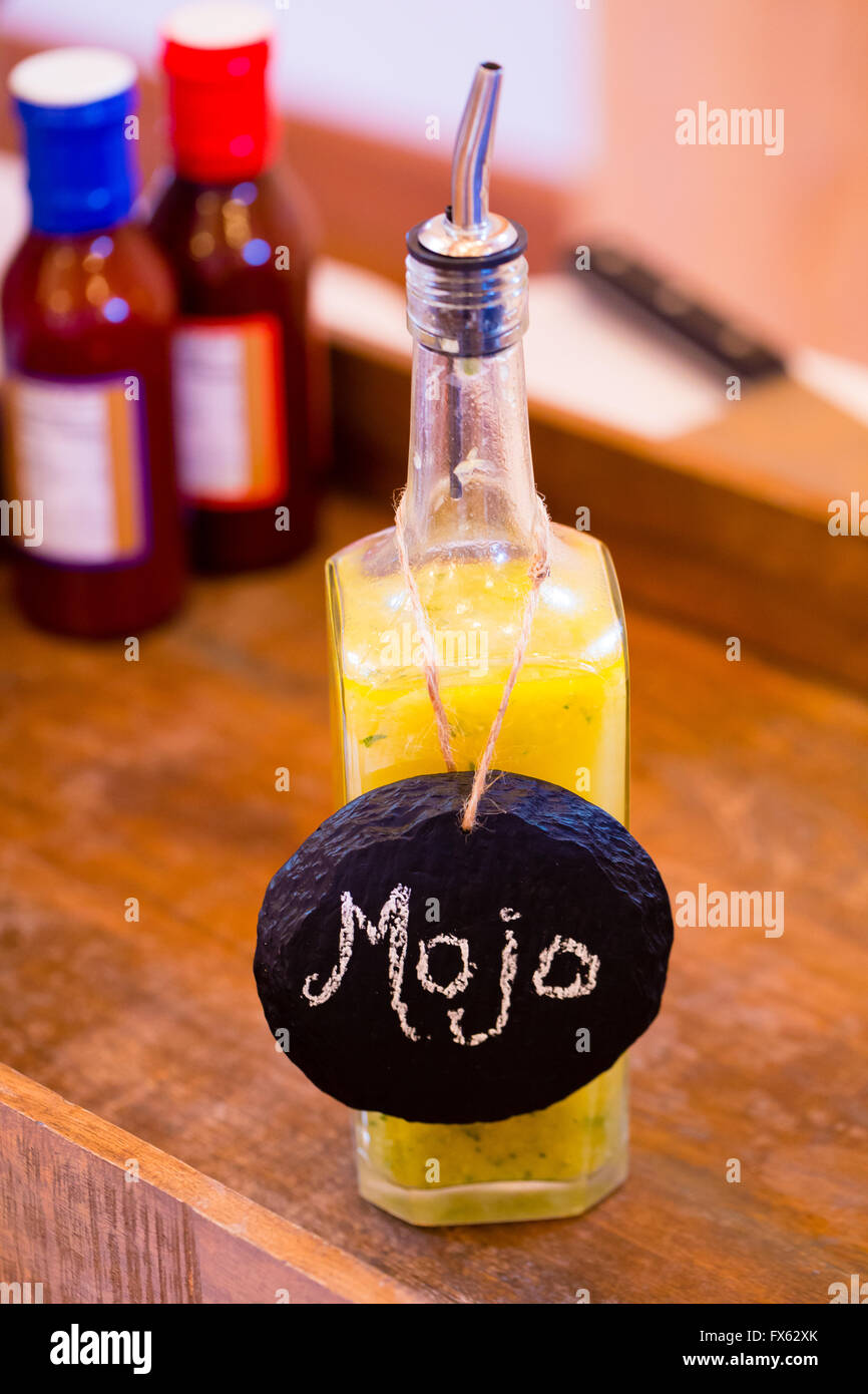 Bbq sauce with a yellow color and a label of mojo at a wedding reception catering bar. Stock Photo