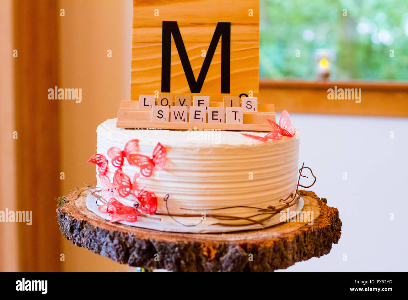 Scrabble letters at a wedding reception are used as decor to spell out the words love is sweet. Stock Photo