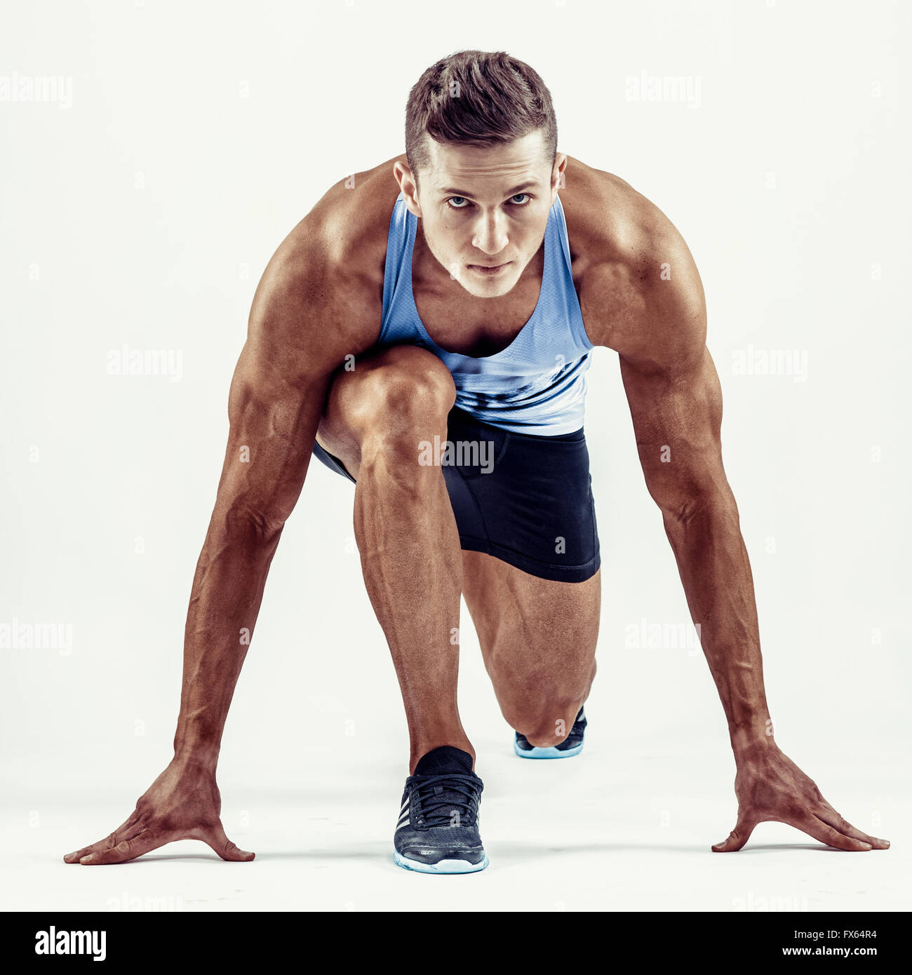 Full length portrait of a fitness man running isolated on a white background Stock Photo