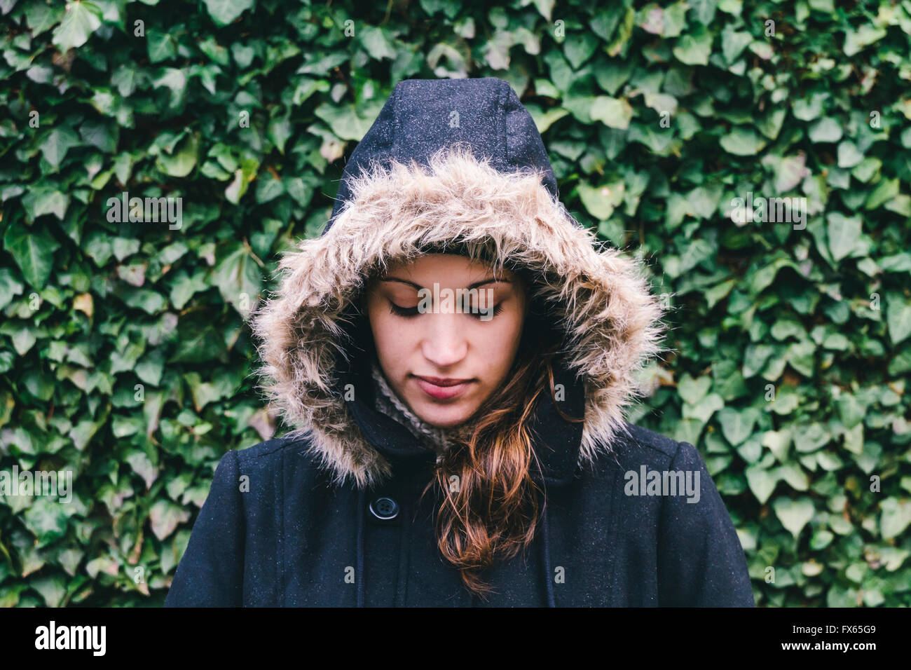 Caucasian woman wearing fur hood Stock Photo