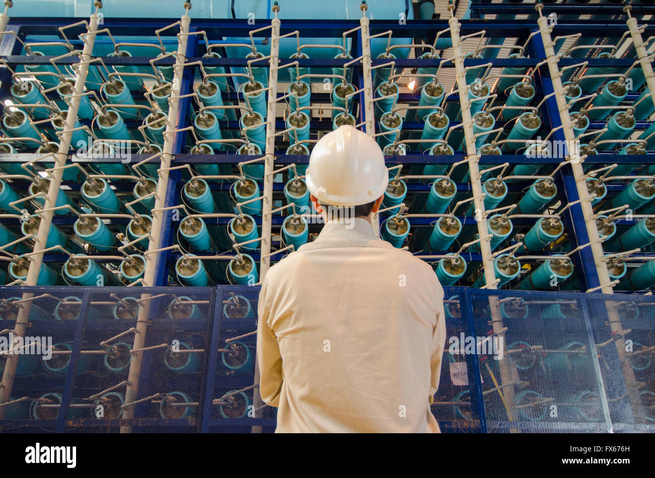 Hispanic technician examining power grid infrastructure Stock Photo