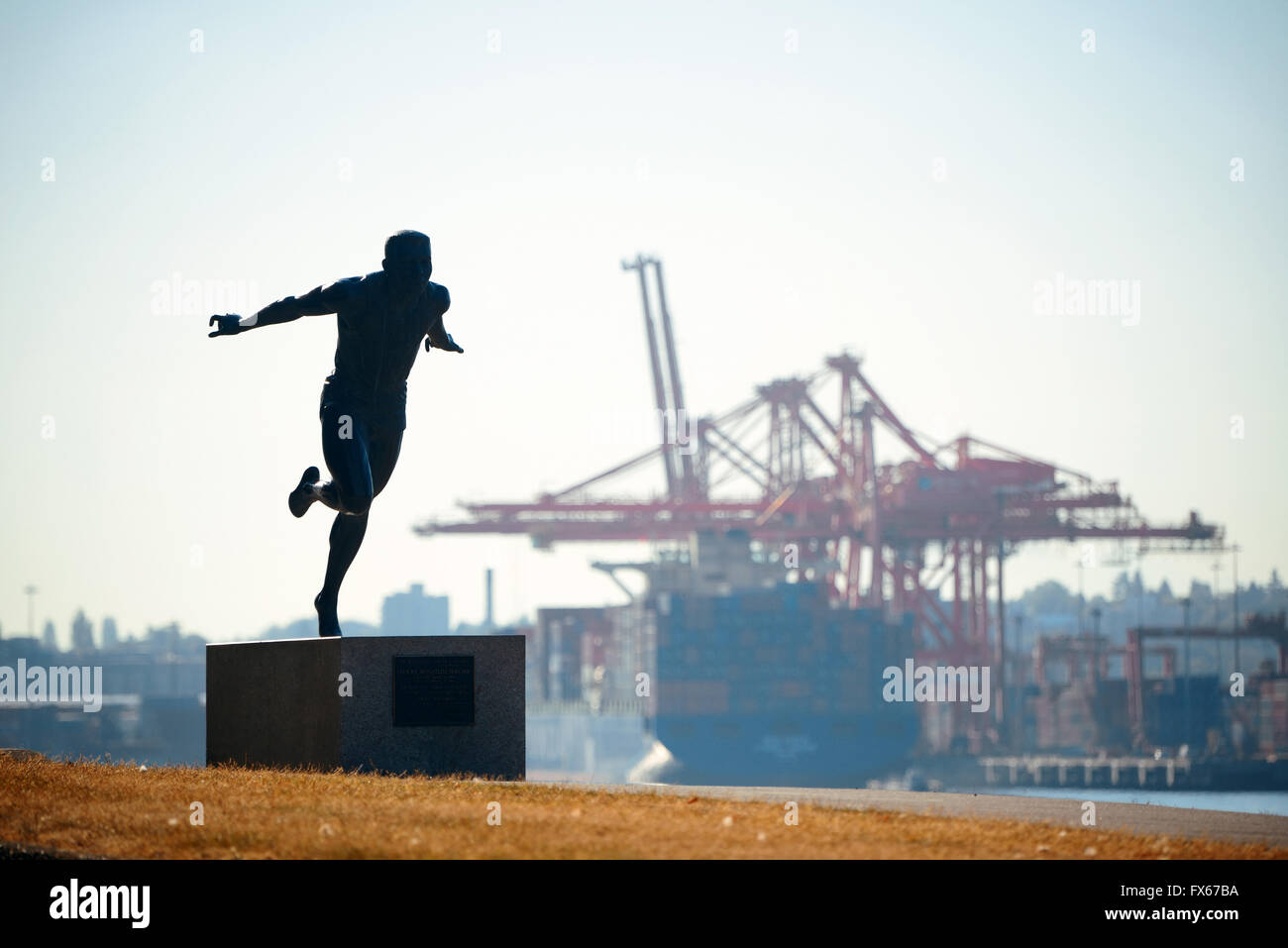 Stanley Park with sculpture of Harry Jerome and cargo crane in Vancouver, Canada Stock Photo