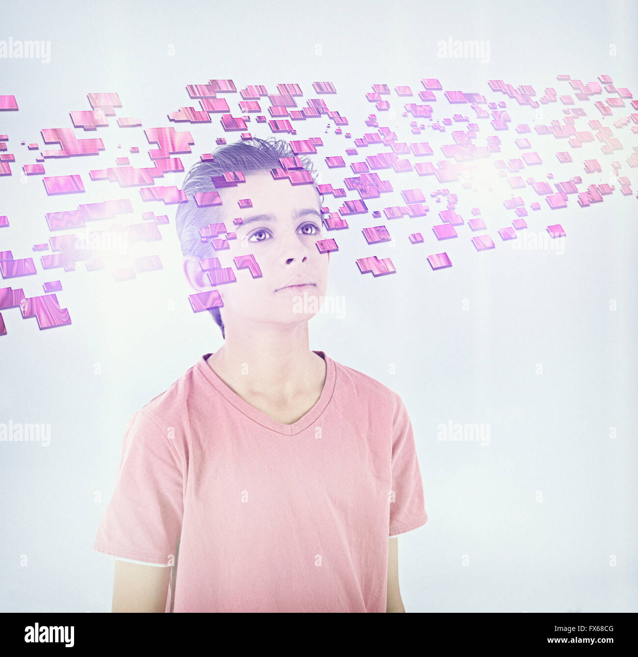 Mixed race boy looking at floating blocks Stock Photo