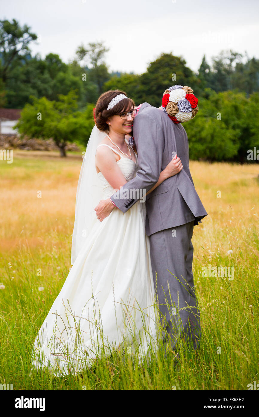 Portrait of a bride and groom outdoors on their wedding day a few minutes before their ceremony. Stock Photo