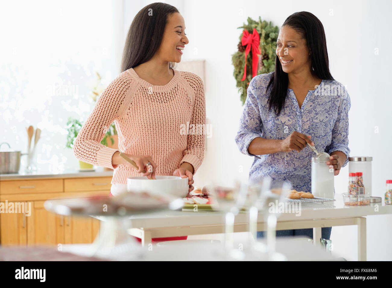 Mother and daughter baking in kitchen Stock Photo