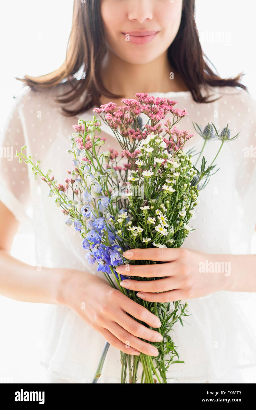 Hispanic woman holding bouquet of flowers Stock Photo - Alamy